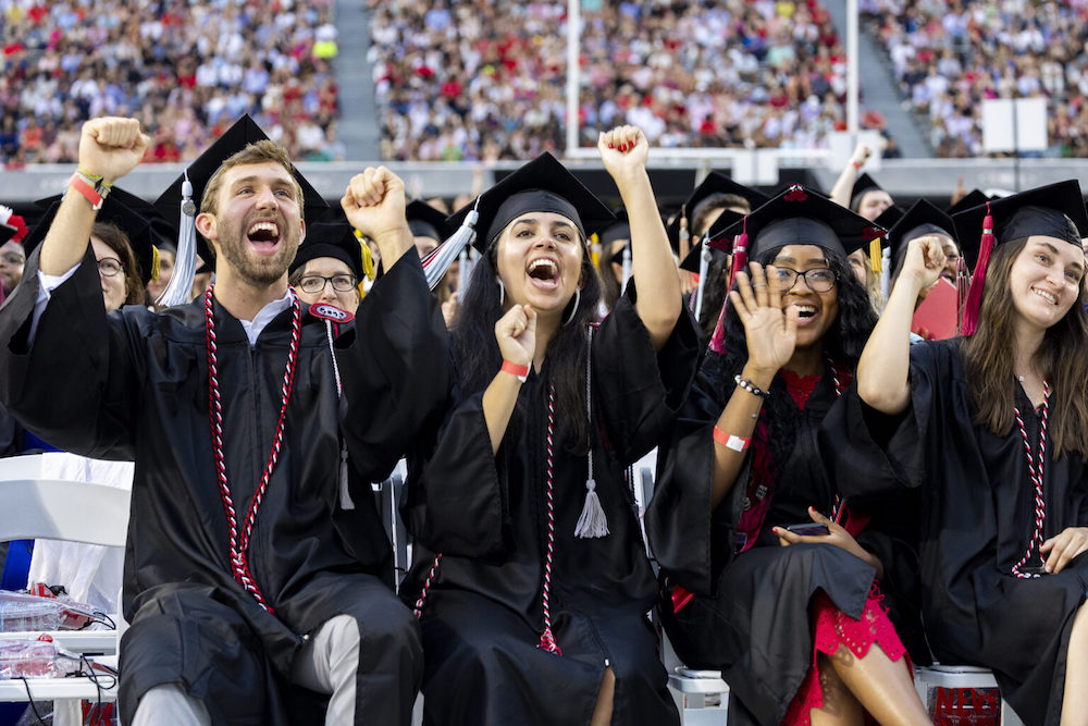 Graduating students celebrate during the Commencement Ceremony at Sanford Stadium.