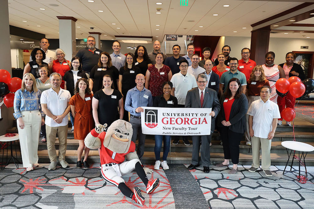 The 2023 New Faculty Tour gets a send-off from UGA President Jere W. Morehead and Public Service and Outreach Vice President Jennifer Frum, with some help from Hairy Dawg. (Photo by Shannah Montgomery)