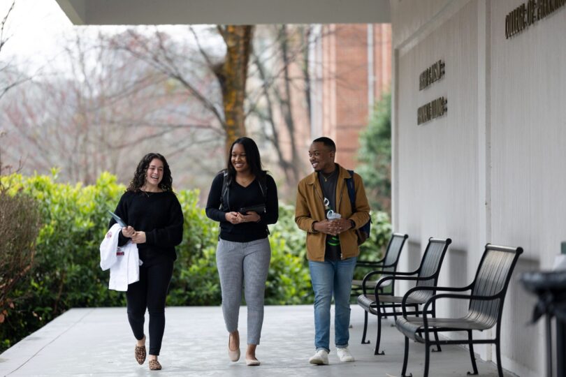 Three students walking together.