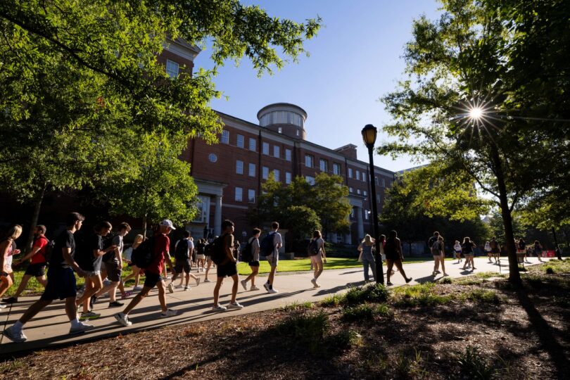 Students walk past the Miller Learning Center on the first day of classes of the 2023 fall semester. (Photo by Andrew Davis Tucker/UGA)