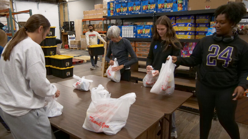 At a recent event hosted by City of Refuge, 10 fellows packed 1,200 bags for students who are dealing with food insecurity. (Photo by Wes Mayer)