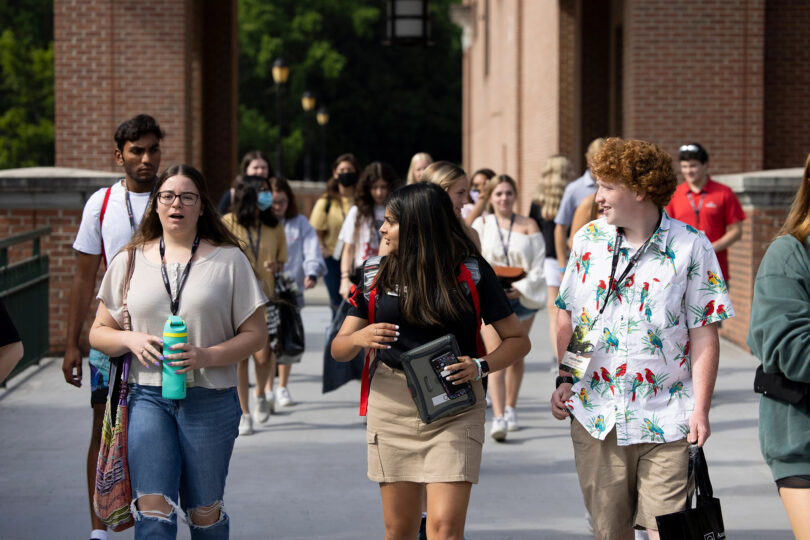 From left, incoming freshman Maris Wright talks with orientation leader Vidhi Patel and fellow freshman Carson Whiee as they walk together to their small group time at new student orientation in the Tate Student Center. (Photo by Andrew Davis Tucker/UGA)