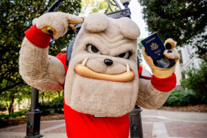 Hairy Dawg mascot holding a U.S. Passport