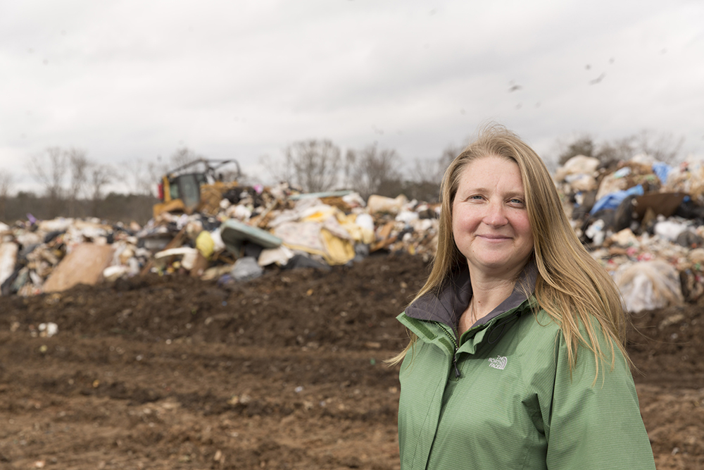 Focus on Faculty; Portrait of Assistant Professor of Environmental Engineering Jenna Jambeck with trash and debris behind her on site at the Athens Clarke County Landfill.