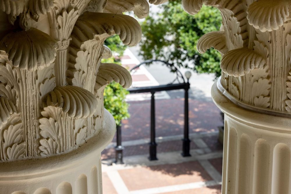 Detail of Holmes-Hunter Academic Building column capitals with the Arch in the background.