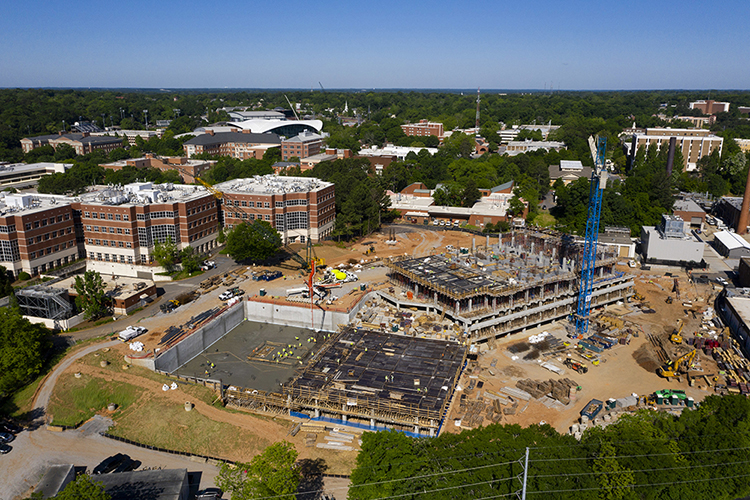 Drone aerials of the I-STEM Research Building under construction between the Davison Life Sciences Complex and East Campus Road.