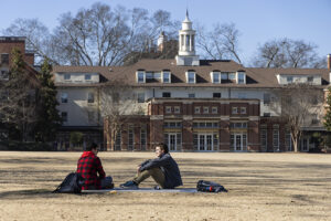 2 people sit in Myers Quad.